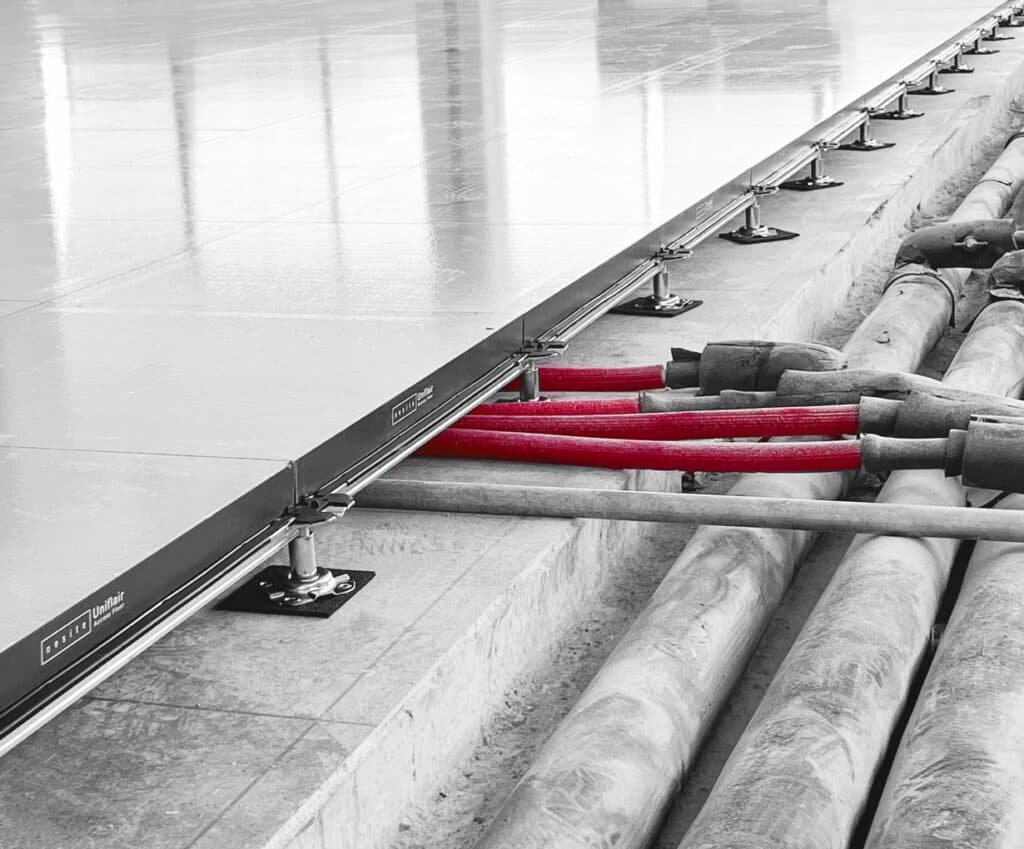Raised floor with open underfloor void — cables and services beneath panels